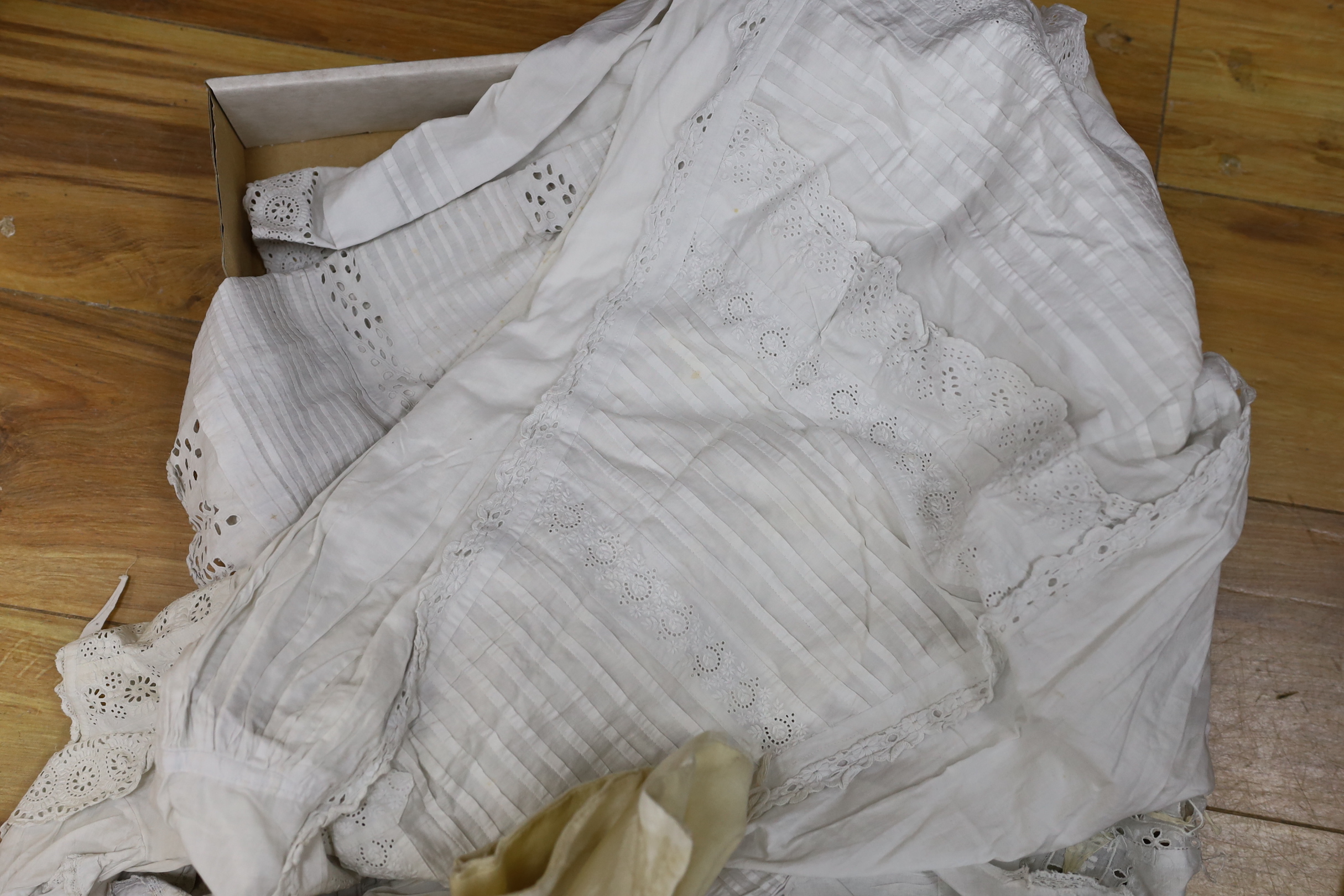 Three Victorian white worked christening gowns, two similar girls aprons and a christening cape